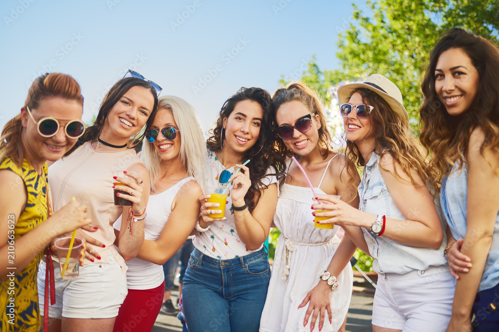 Group of female friends posing and having a good time at the outdoor party/music festival Group of female friends posing and having a good time at the outdoor party/music festival