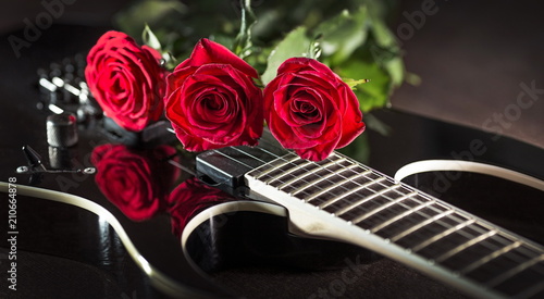 three roses on black guitar