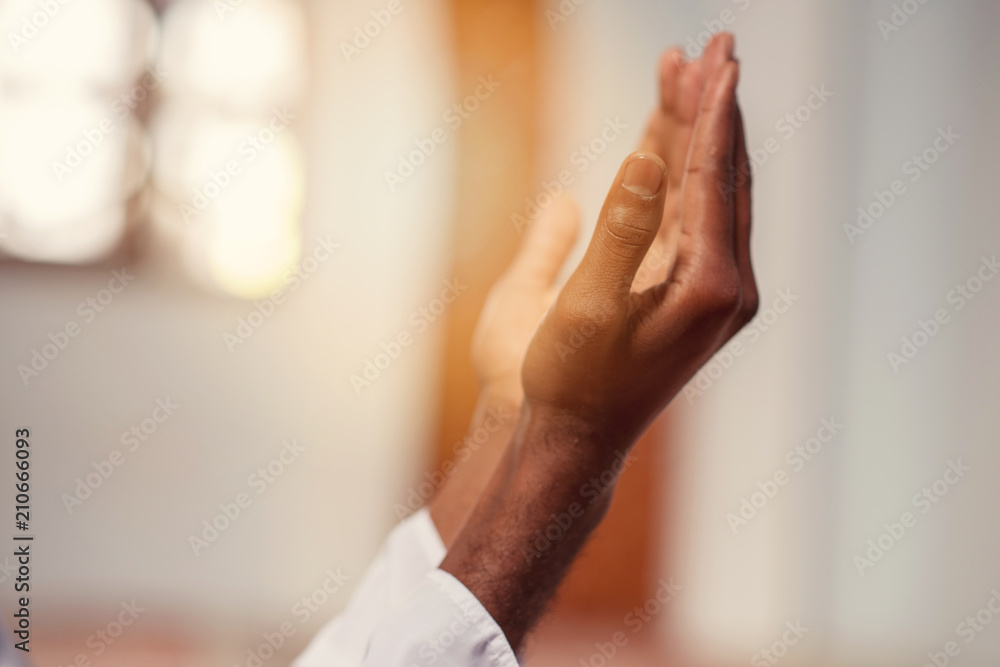 Fototapeta premium Hand of muslim black man people praying with mosque interior background