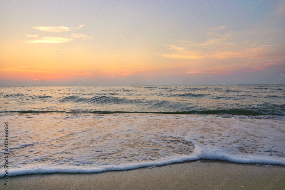 Morning on sea, Beautiful nature blue sky with clouds. Colorful sky as a background. Soft wave of the sea on the sandy beach at  Cha-am beach, Thailand. Space for text in template. Travel concept.