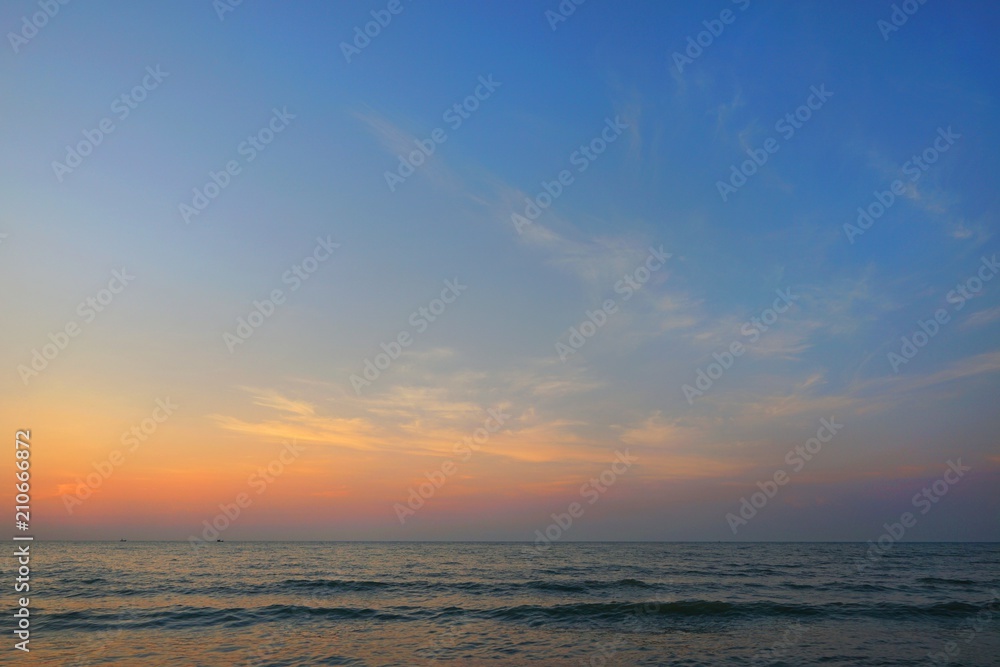 Morning on sea, Beautiful nature blue sky with clouds. Colorful sky as a background. Soft wave of the sea on the sandy beach at  Cha-am beach, Thailand. Space for text in template. Travel concept.