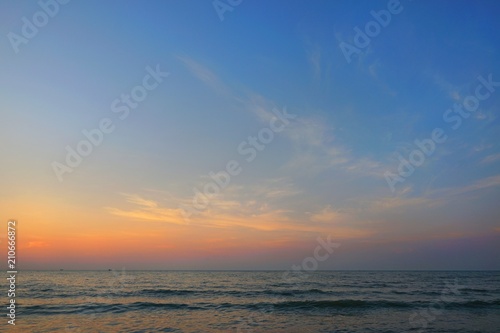 Morning on sea, Beautiful nature blue sky with clouds. Colorful sky as a background. Soft wave of the sea on the sandy beach at Cha-am beach, Thailand. Space for text in template. Travel concept. © Dark Caramel