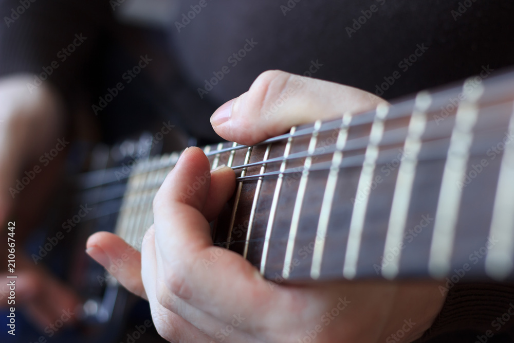 Man is playing guitar close up