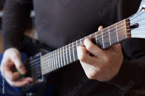Man is playing guitar close up