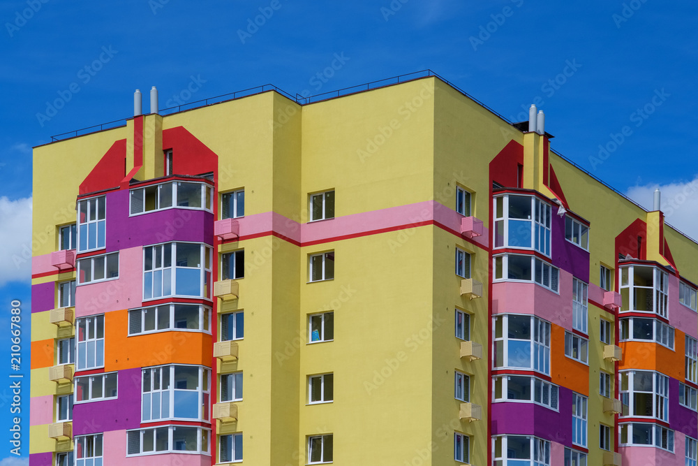 new high building of yellow color with colorful balconies