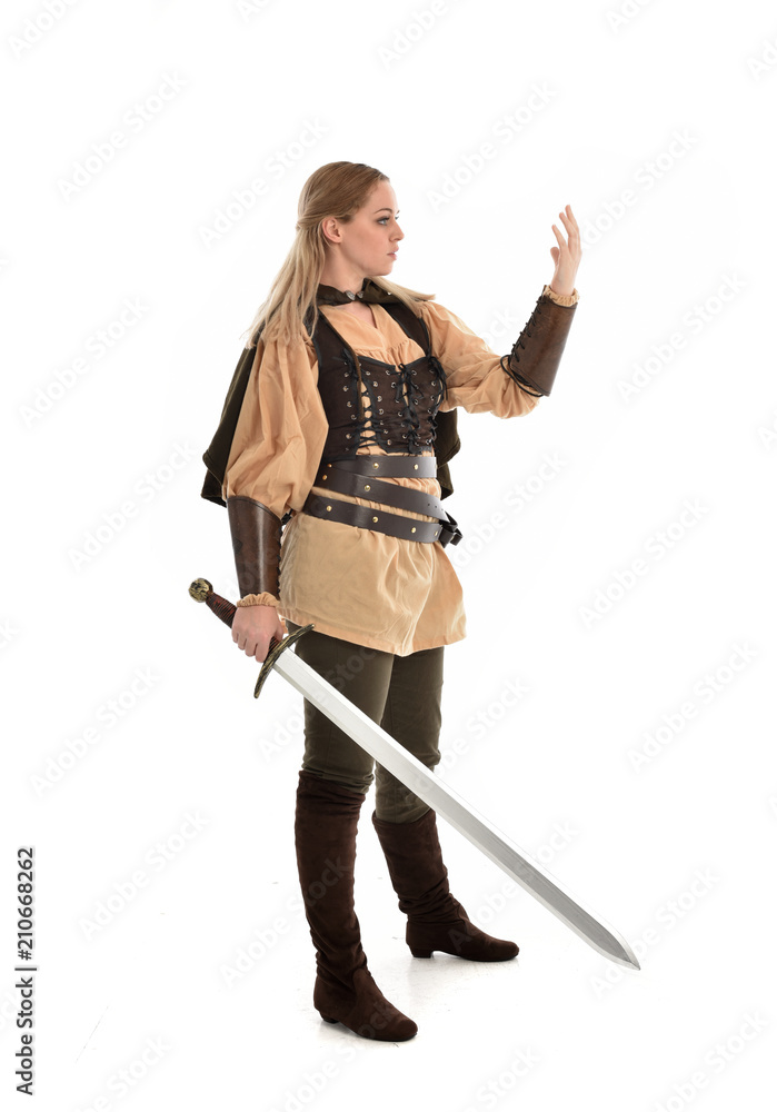full length portrait of girl wearing brown medieval costume,. standing pose, isolated on white studio background. full length portrait of girl wearing brown medieval costume,. standing pose, isolated on white studio background.