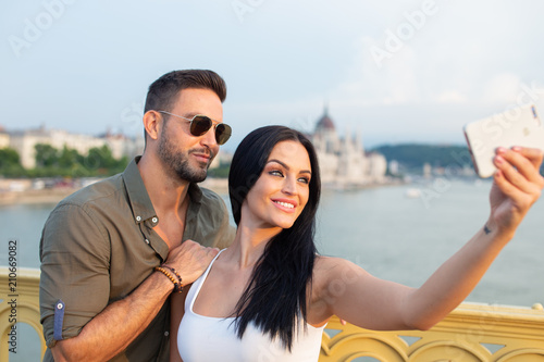 Happy young couple taking selfie at Budapest