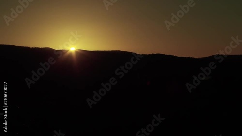 Wallpaper Mural A scenic steady shot of a sun setting. The sun shines a bright yellow color. Torontodigital.ca