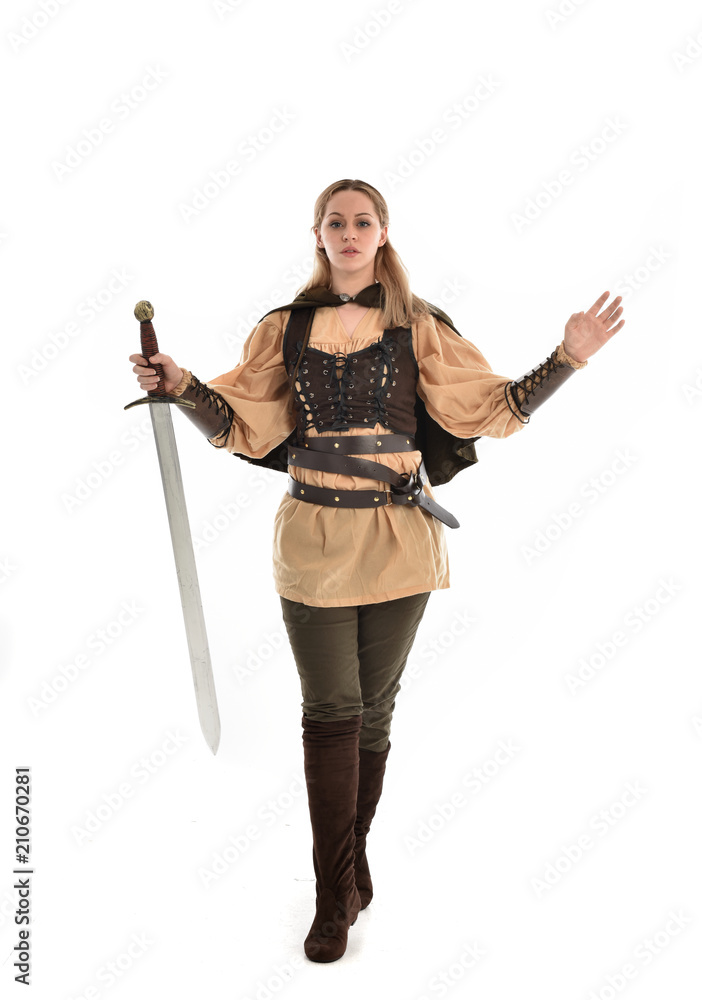 full length portrait of girl wearing brown medieval costume,. standing pose, isolated on white studio background. full length portrait of girl wearing brown medieval costume,. standing pose, isolated on white studio background.