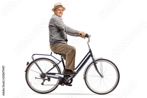Senior riding a bike and looking at the camera