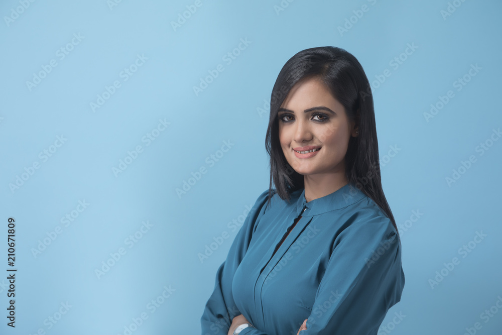 Portrait of smiling businesswoman over blue background