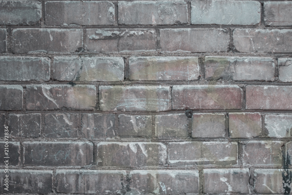 An old weathered brick wall with grungy texture An old weathered brick wall with grungy texture