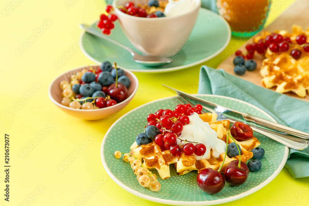 Breakfast with waffles, wipped cream, berries and granola Breakfast with waffles, wipped cream, berries and granola
