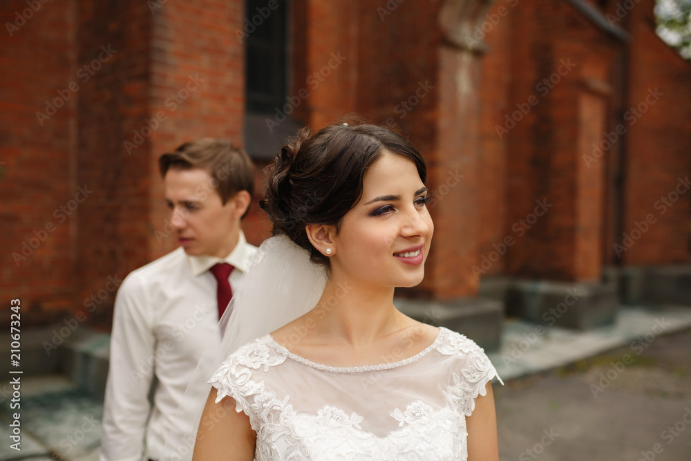 Happy bride and groom walking outdoors. Just married. Wedding concept.