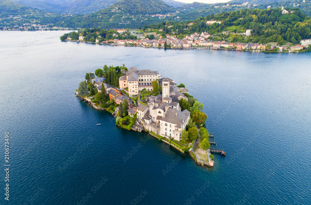 The very suggestive and romantic island of San Giulio in Orta lake, Piedmont, Italy. Aerial view.