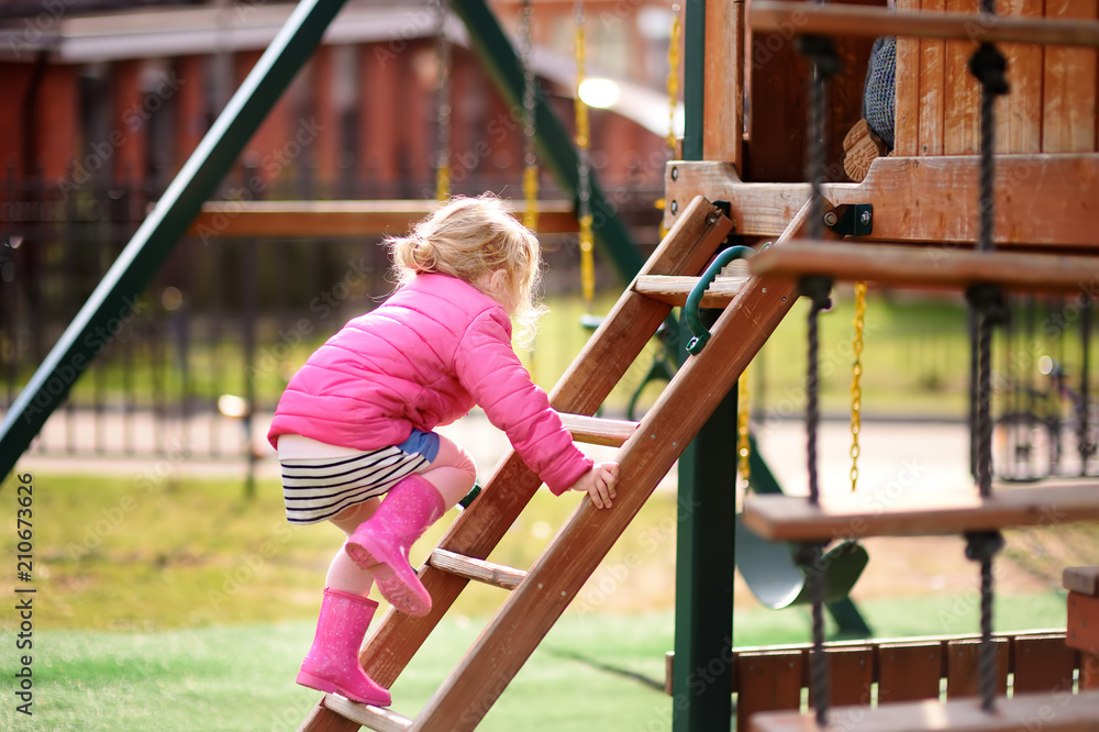 Cute little girl having fun on outdoor playground Cute little girl having fun on outdoor playground
