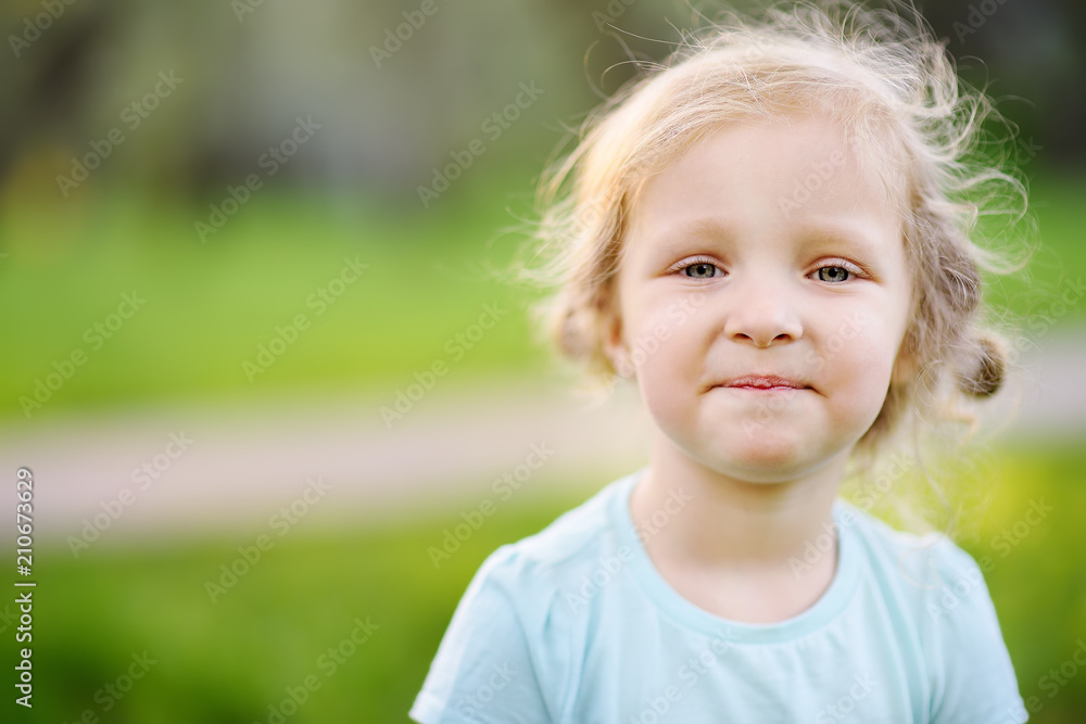 Cute toddler girl outdoors portrait in summer day Cute toddler girl outdoors portrait in summer day