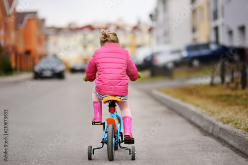 Cute little girl learning ride a bicycle © Maria Sbytova