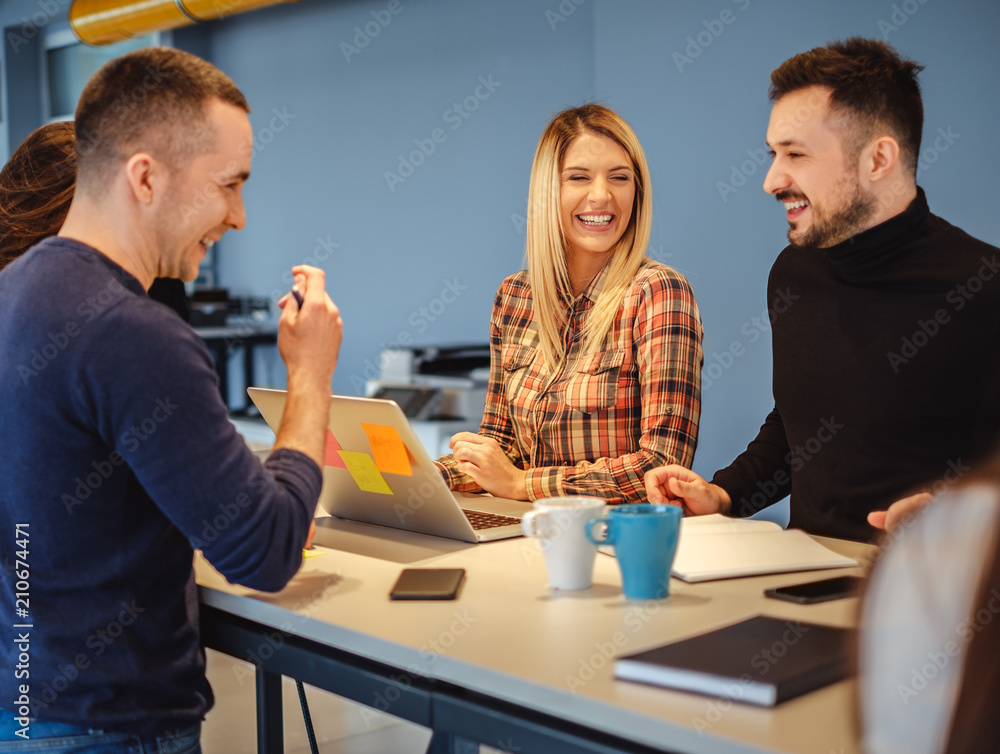 Fototapeta premium Creative people laughing at office meeting