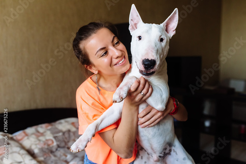 Canvas Print Cute girl petting her bull terrier