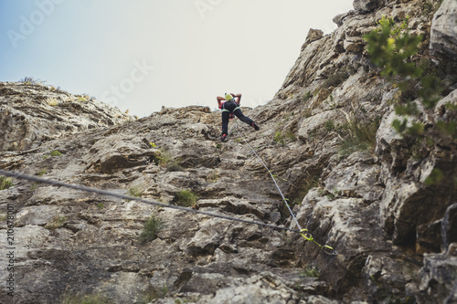 Woman Climbing a Mountain