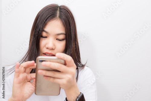 Fototapeta Naklejka Na Ścianę i Meble -  Beautiful short hair women texting message on smartphone