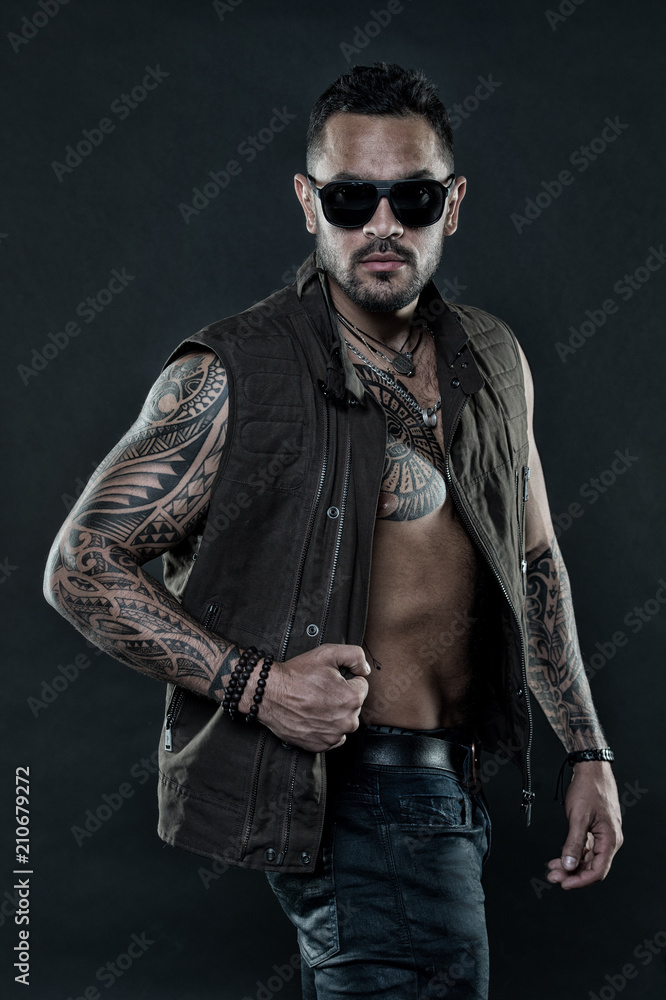 Tattoo model with beard on unshaven face. Tattooed man with six pack and  ab. Bearded man
