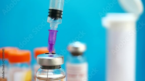 Holding syringe and medicine vial prepare for injection with surgical equipment and medicine vial background. Russia coronavirus vaccine, Sputnik V. Covid-19 vaccination concept