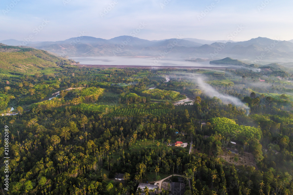 Fototapeta premium Village in tropical forest with canal river morning sunrise