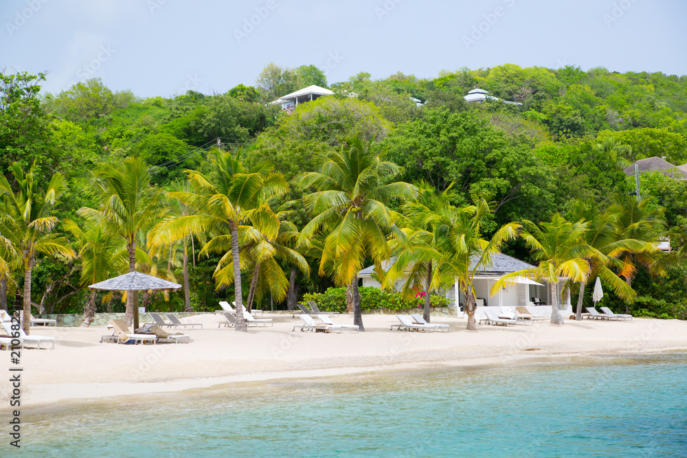Obraz premium Antigua, Caribbean islands. English Harbour view with Galeon beach, sun beds and umbrellas