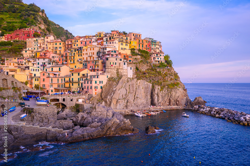 Manarola - Village of Cinque Terre National Park at Coast of Italy. Beautiful colors at sunset. Province of La Spezia, Liguria, in the north of Italy - Travel destination and attractions in Europe.