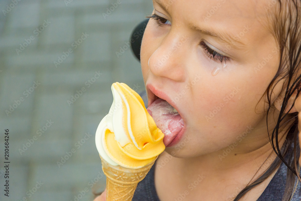 Sad weeping child girl licking ice cream Stock Photo | Adobe Stock