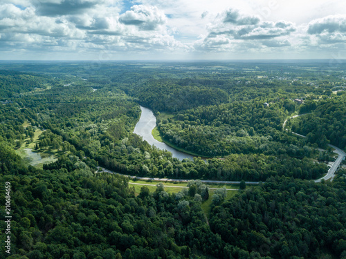 drone image. aerial view of rural area with dramatic clouds over river of Gauja in Sigulda district. Latvia