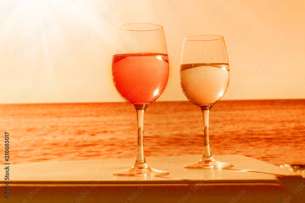 Two glasses by sea in orange
