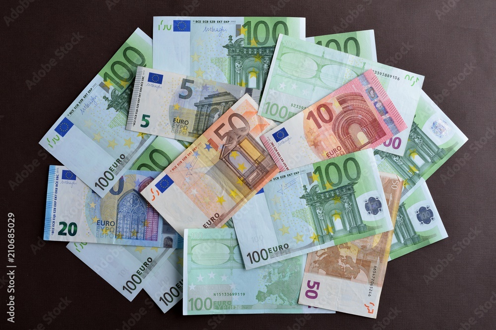 Euro cash background. Pile of different euro banknotes on the ta Euro cash background. Pile of different euro banknotes on the ta