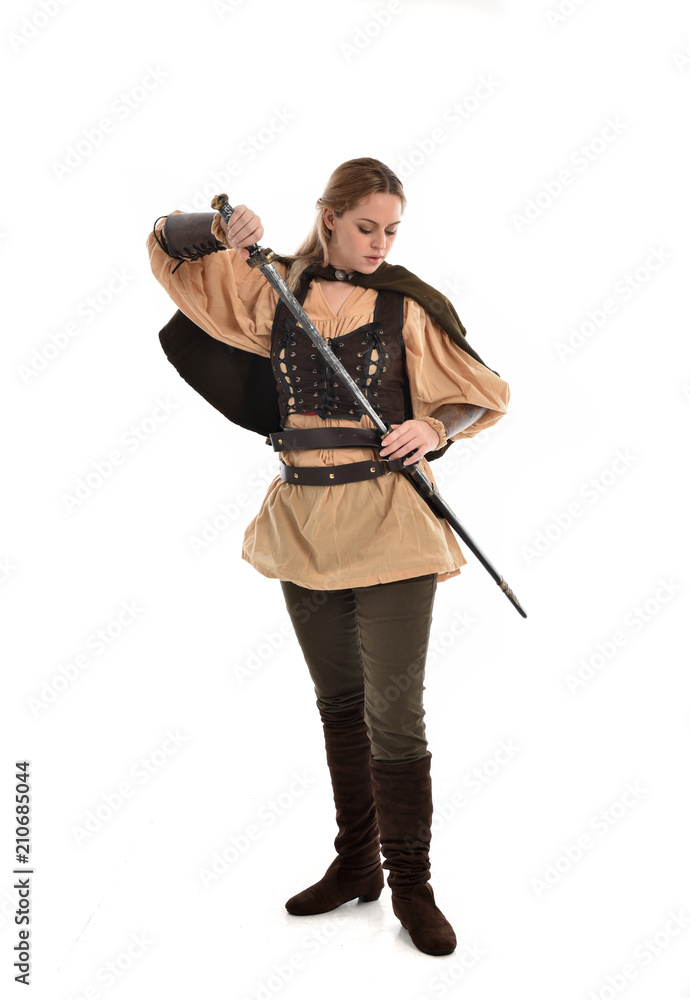 full length portrait of girl wearing brown medieval costume,. standing pose, isolated on white studio background. full length portrait of girl wearing brown medieval costume,. standing pose, isolated on white studio background.