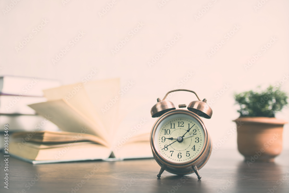 clock and books on table for time to learning and knowledge concept clock and books on table for time to learning and knowledge concept
