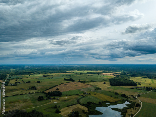 drone image. aerial view of rural area with houses and roads under heavy rain clouds