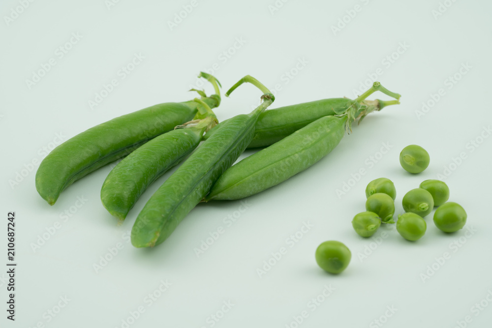 Fresh harvest green pea pods and peas from my garden on white background Fresh harvest green pea pods and peas from my garden on white background