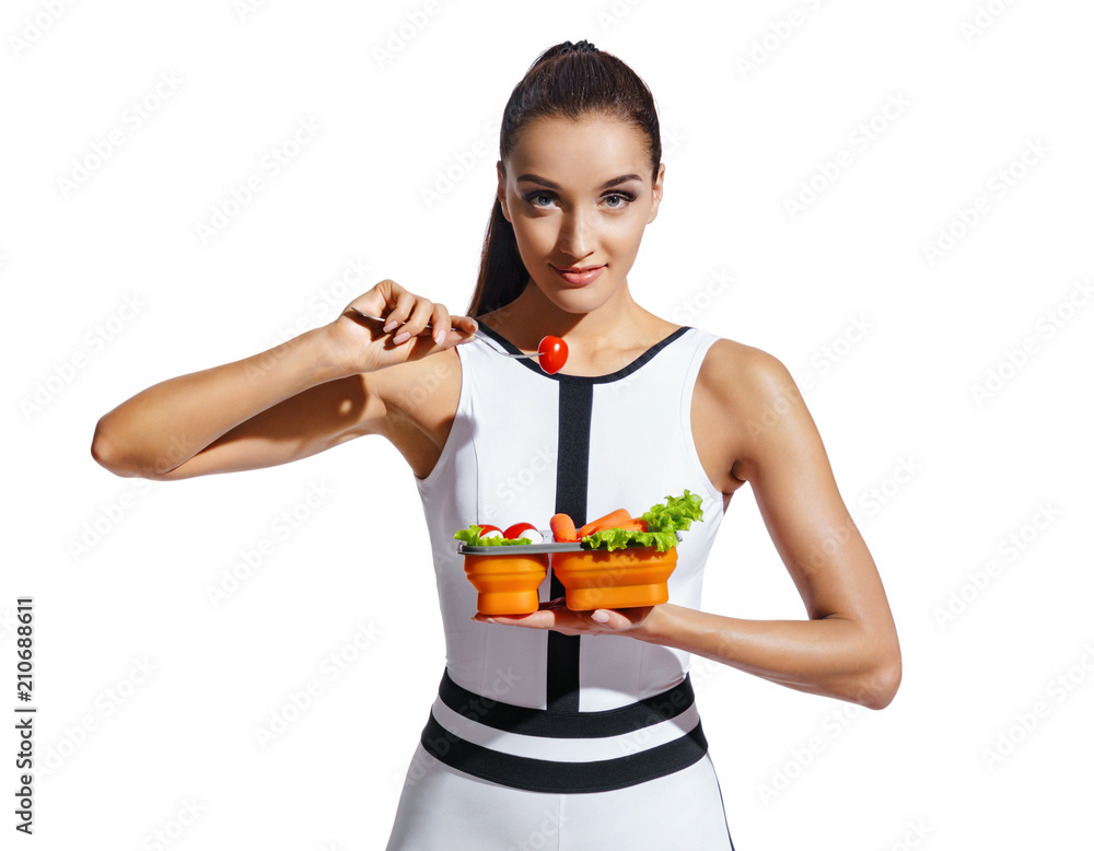 Sporty girl holding container with healthy nutrition. Photo of fitness model in fashionable sportswear isolated on white background. Healthy nutrition Sporty girl holding container with healthy nutrition. Photo of fitness model in fashionable sportswear isolated on white background. Healthy nutrition