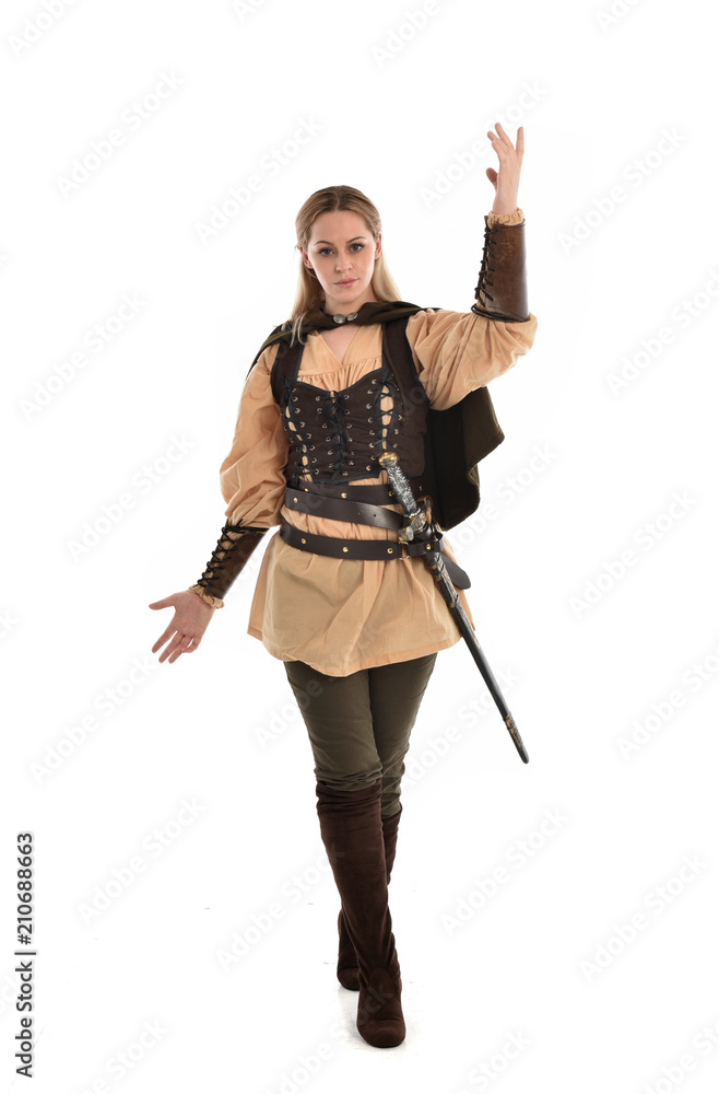 full length portrait of girl wearing brown medieval costume,. standing pose, isolated on white studio background. full length portrait of girl wearing brown medieval costume,. standing pose, isolated on white studio background.