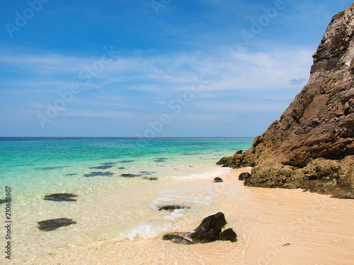 Beach and turquoise water sea with clear blue sky in sunny summer day for vacation holiday concept.