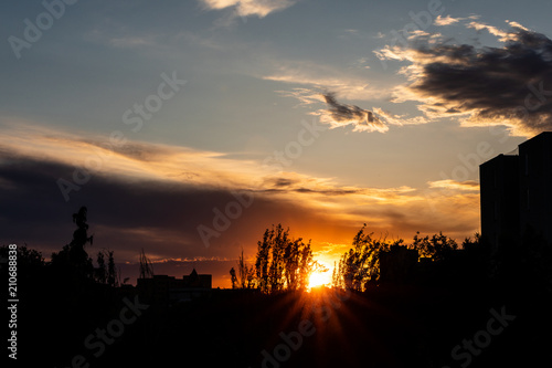 Silhouettes of trees and buildings at sunset in Madrid
