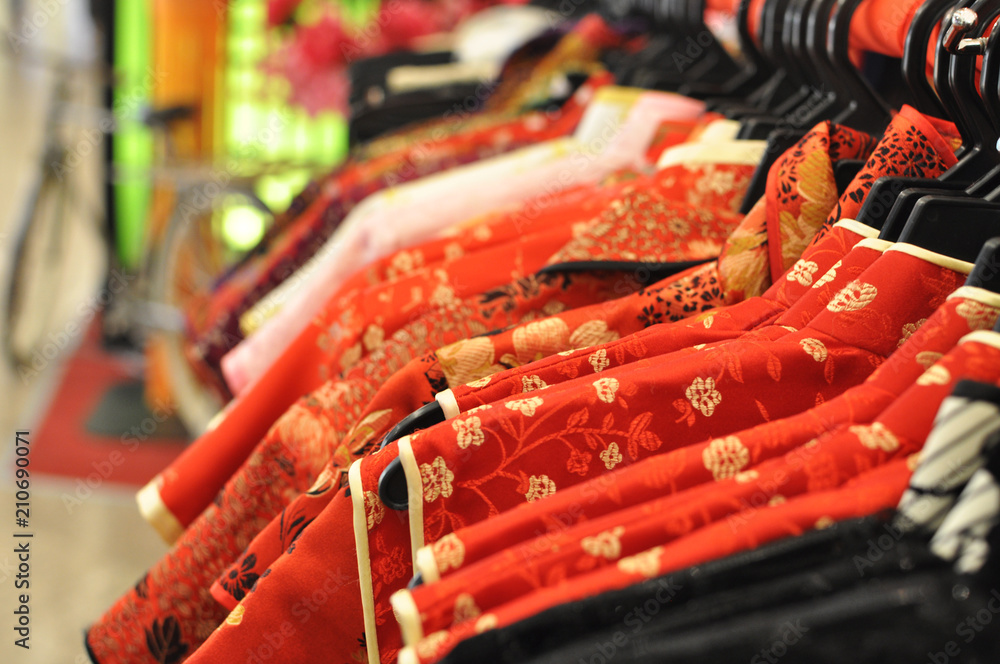 Traditional Chinese Cheongsam on sale during lunar new year, display on clothes rack in shopping mall