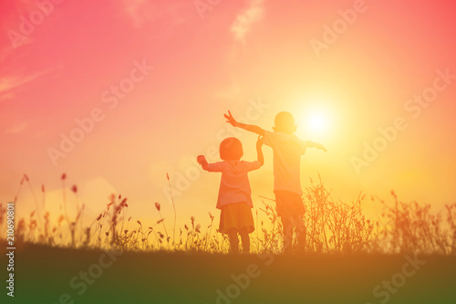 silhouette of a happy children and happy time sunset