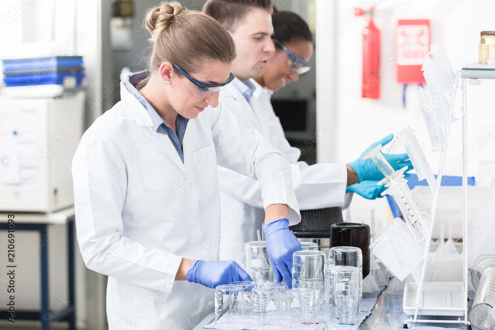 Scientists in research lab with safety goggles Scientists in research lab with safety goggles