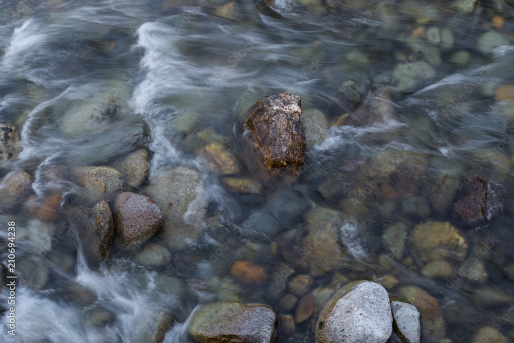 Multicolored stones under the river Multicolored stones under the river