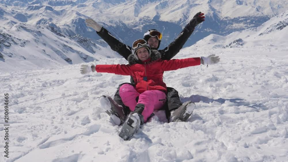 In The Mountains Portrait Of A Happy Couple Of Skiers Smiling And Raises Arms In The Mountains Portrait Of A Happy Couple Of Skiers Smiling And Raises Arms