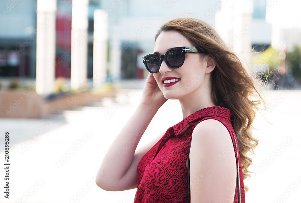 Young smiling woman wearing sunglasses Young smiling woman wearing sunglasses