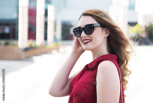Young smiling woman wearing sunglasses